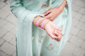 Chudiyan. Bracelets on the girl's hands. Traditional accessories of Indian girls. Girl in traditional Indian clothing, salwar kameez.