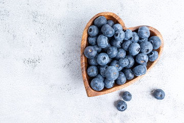 healthy eating antioxidant blueberries in a wooden bowl heart shaped top view