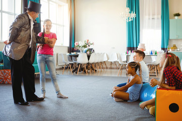 Magician, an illusionist shows tricks.