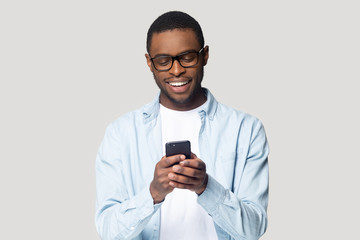 Joyful smiling african american young man playing online game.