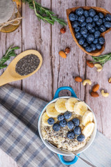 rustic Breakfast oatmeal with berries and banana with Chia seeds top view