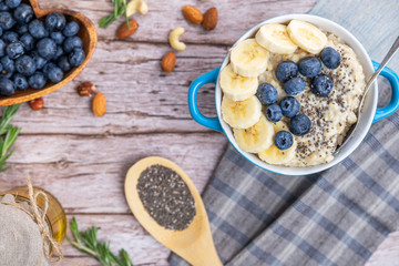 rustic Breakfast oatmeal with berries and banana with Chia seeds top view
