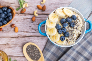 rustic Breakfast oatmeal with berries and banana with Chia seeds top view - 308897955