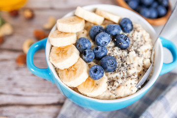oatmeal with banana and blueberries in a blue bowl