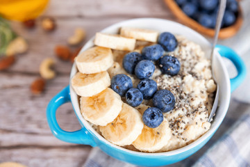 oatmeal with banana and blueberries in a blue bowl