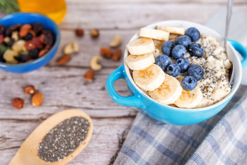 oatmeal with banana and blueberries in a blue bowl
