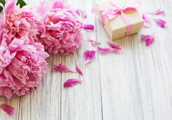 Background with peonies and gift box