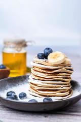 .American pancakes with blueberries and honey