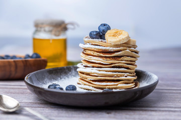 .American pancakes with blueberries and honey