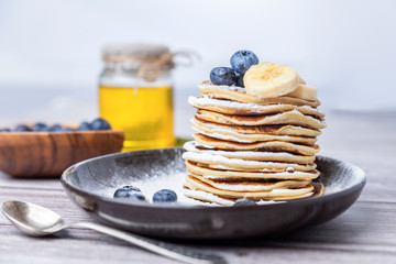 .American pancakes with blueberries and honey