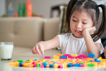 Asian happy girl playing block at home, Asian family concept