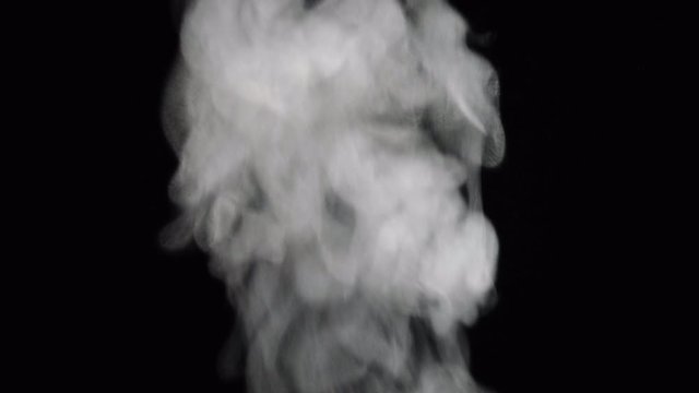 closeup white vapor stream rises from bottom center on black background