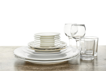 Set of clean tableware on white background
