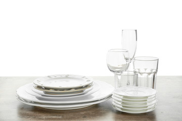 Set of clean tableware on white background