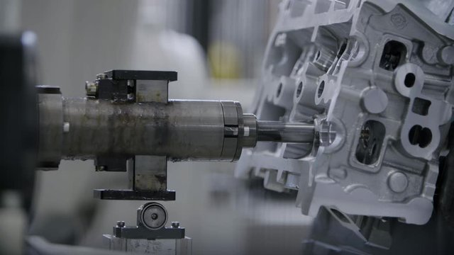 Car engine assembly on the production line inside an automobile manufacturing plant