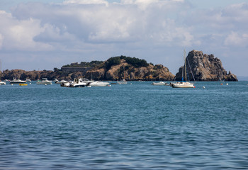 Fototapeta na wymiar Fishing boats and yachts moored in the bay at high tide in Cancale, famous oysters production town. Brittany, France,