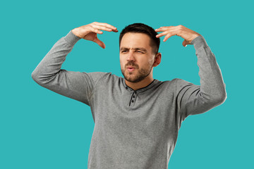 Fototapeta premium portrait of furious enraged bearded man shouting and screaming isolated on blue background