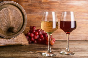 Glasses of different wine on wooden table
