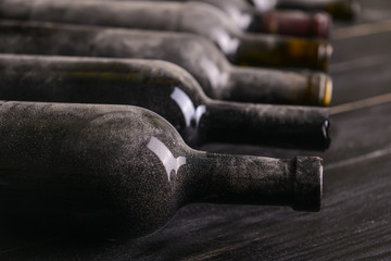 Bottles of wine on wooden table, closeup