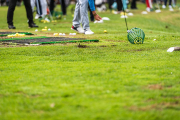 Golfer legs at golf tournament practice swing with golf club.