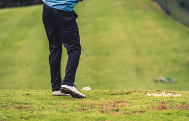 Golfer legs at golf tournament practice swing with driver.