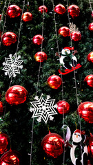 Christmas decoration. Hanging red balls and Snowflake on pine branches and tree background.
