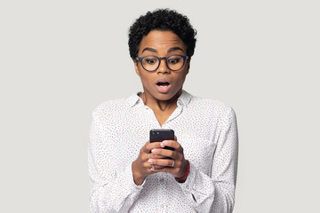 Astonished young african american woman received unexpected news.