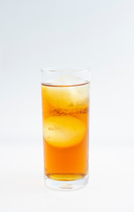 Yellow juice in ice glass