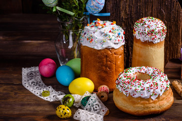 Easter cake and colorful eggs on a dark background