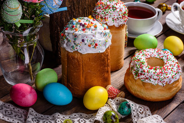 Easter cake and colorful eggs on a dark background