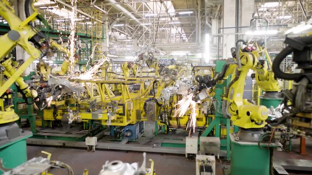 Automated robots at work inside an automobile manufacturing plant