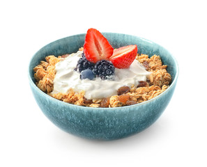 Tasty granola with yogurt in bowl on white background