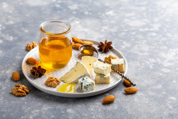 Cheese platter with nuts and honey