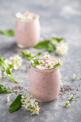 Glass jar fillled with pink yogurt