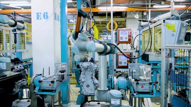 Automated robots at work inside an automobile manufacturing plant