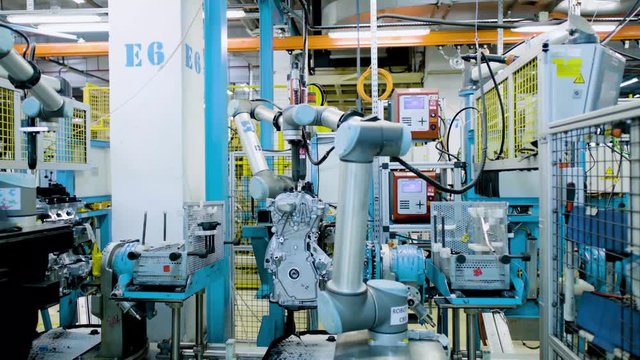 Automated robots at work inside an automobile manufacturing plant