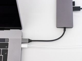 Laptop with usb-c hub on white desk