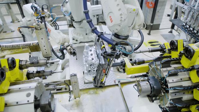 Car engine assembly on the production line inside an automobile manufacturing plant