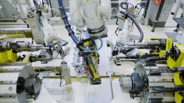 Car engine assembly on the production line inside an automobile manufacturing plant