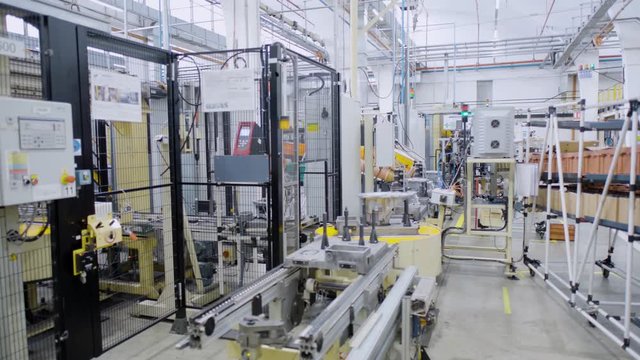 Car engine assembly on the production line inside an automobile manufacturing plant
