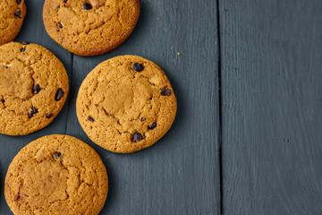 Chocolate cookies on a dark wooden table. Top view.