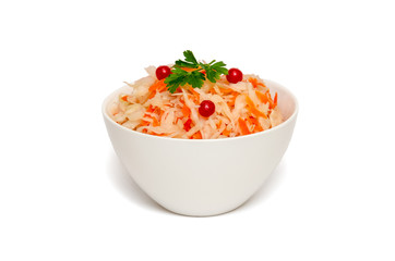 Sauerkraut with carrot in white ceramic bowl on white background. Homemade fermented food. Healthy eating and diet concept. Closeup. Copy space