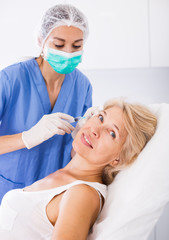 Woman during beauty facial injections