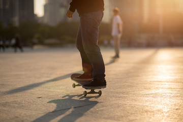 Skateboarder skateboarding at sunset city