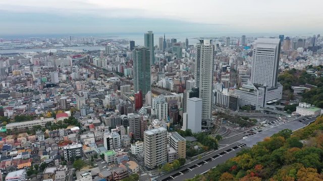 Aerial view of cityscape of Kobe, skyscrapers and other modern buildings skyline of Japanese city, sea on horizon - landscape panorama of Japan from above, Asia