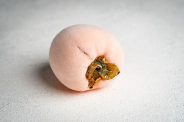 Frozen  ripe persimmon fruit isolate on a light background. Copy space.