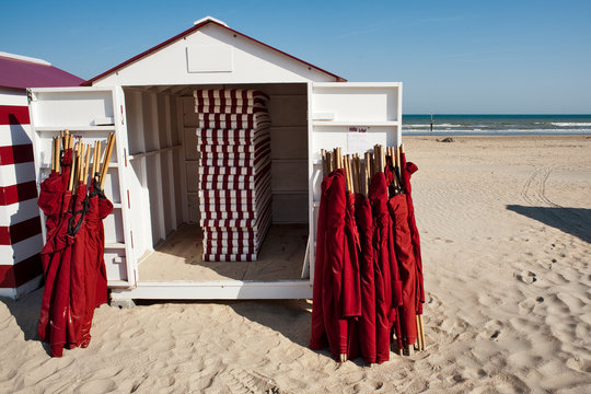 umbrellas and bathing cabins on the beach of De Panne in Belgium