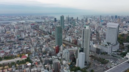 Aerial view of cityscape of Kobe, skyscrapers and other modern buildings skyline of Japanese city, sea on horizon - landscape panorama of Japan from above, Asia
