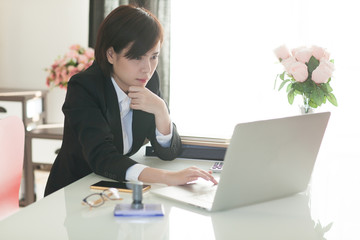Young Asian short hair female model in formal dress which is good for business purpose