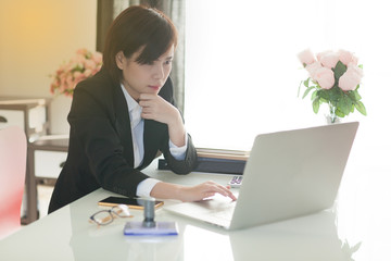 Young Asian short hair female model in formal dress which is good for business purpose